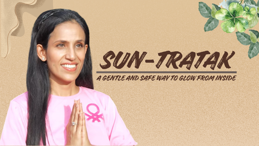 Woman in a pink top standing outdoors with hands in prayer position, introducing Sun-Tratak as a gentle morning practice for inner calm and natural glow.